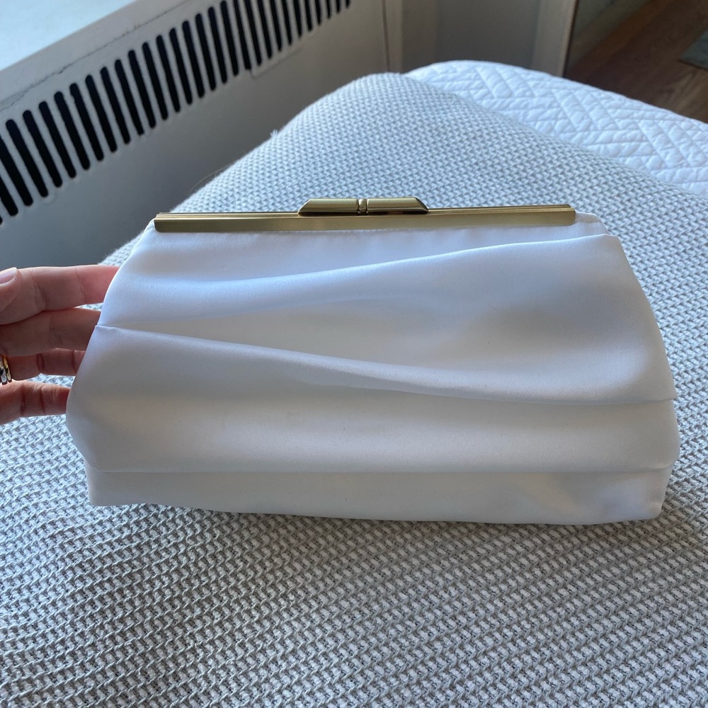 White clutch with gold detail. New never used.